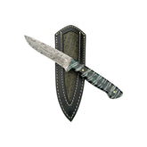 Custom Damascus mammoth hunting knife 26-557 resting across its stitched sheath with a textured inset.