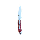 Reverse side of Yooper pocket knife 26-546 with blade open, pink-red box elder burl handle and silver pocket clip