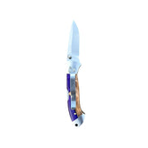 Reverse side of Yooper pocket knife 26-550 with blade open, purple acrylic and tan burl handle, and silver pocket clip